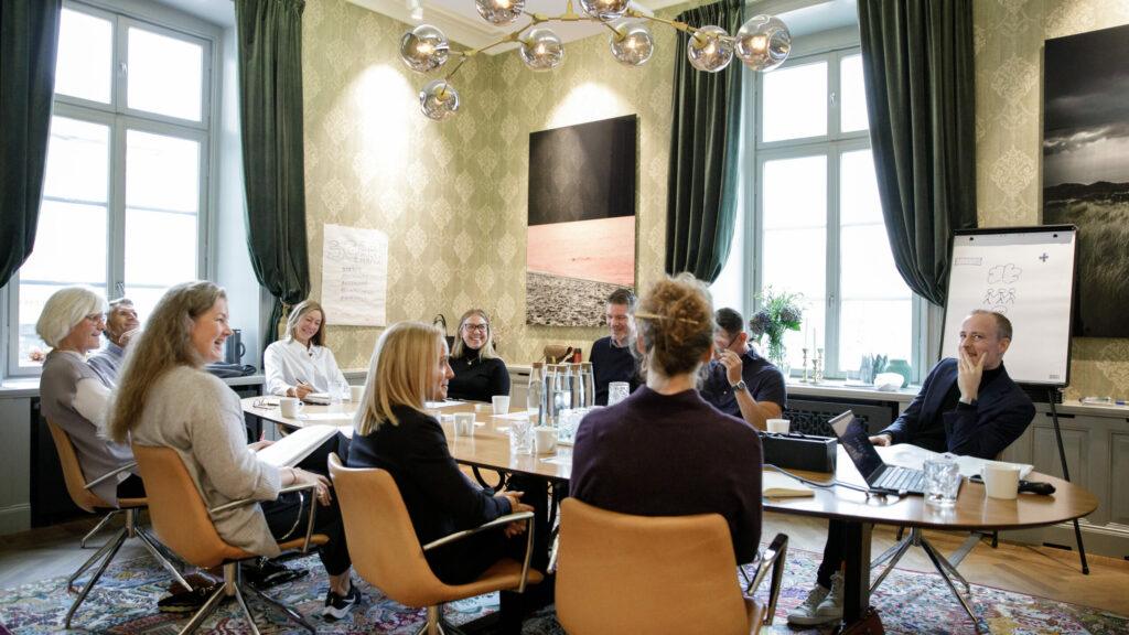 Team i möte där ledarskap, struktur och samarbete diskuteras